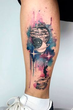 a woman's leg with a watercolor tattoo on it