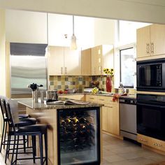 a kitchen filled with lots of appliances and counter top space next to a stove top oven