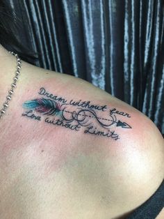 a woman with a tattoo on her shoulder that says dream without fear, love cannot limits