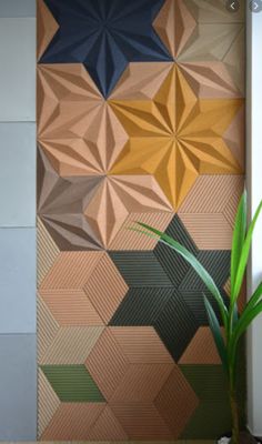 a potted plant sitting on top of a wooden table next to a wall mural