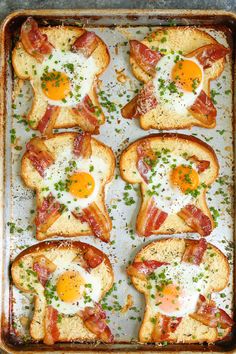 toasted eggs and bacon are arranged on top of each other