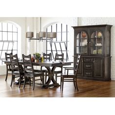 a dining room table with chairs and a china cabinet