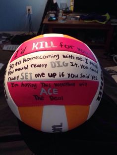 a beach ball with writing on it sitting in front of a computer desk