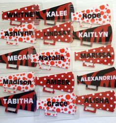 red, white and black name tags with polka dots on them are arranged in rows