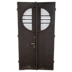 an old wooden door with two round glass panels on the front and side doors to both sides