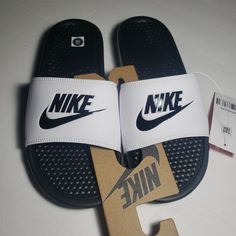 Mens Nike Slides Side 8 Benassi Jdi White Upper With Black Emblem And Black Bottoms Nike Slides Men, Nike Slide Sandals, Nike Benassi Slides, Nike Flip Flops, Shower Sandals, Nike Sandals, White Sleeves, Nike Benassi, Nike Slides