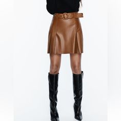 High Waisted Skirt With Self Belt Pleat Detail Back Hidden Inseam Zip Closure Whiskey Fall Season Belted Mini Skirt, Belted Brown Skirt, Fall High Waist Belted Mini Skirt, Belted High-waist Mini Skirt For Fall, High Waist Belted Mini Skirt For Fall, Brown Belted Fitted Mini Skirt, Fall Leather Pleated Mini Skirt, Brown Belted Skirt For Workwear, Brown Fitted Belted Mini Skirt