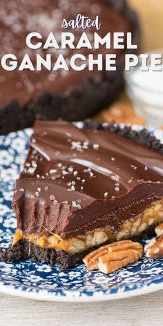 a piece of chocolate caramel ganache pie on a blue and white plate with pecans