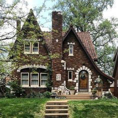 a small brick house with steps leading up to the front door and windows on each side