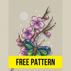 a cross stitch pattern with pink flowers and a butterfly on the side, in front of a