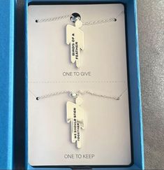 two necklaces in a blue box that say one to give and one to keep