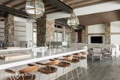 a large kitchen with an island and lots of counter space in front of the bar