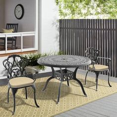 an outdoor table and chairs on a patio