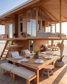 a wooden table sitting on top of a wooden floor next to a building with lots of windows