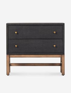 the sideboard with two drawers is made from wood and has black fabric on it