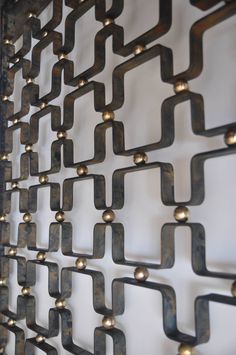 a metal wall hanging on the side of a building