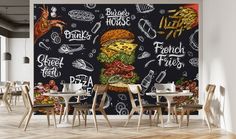 a chalkboard wall mural in a dining room with french fries and burgers on it