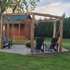 a wooden gazebo with swings and chairs in the grass