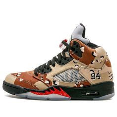 Nike and Supreme teamed up in 2015 to release a limited edition Air Jordan 5 Retro sneaker in three colorways. The Desert Camo version of the sneaker was the most popular and sold out instantly. The sneaker features Supreme branding across the netting and the number ‘94’ on the heel representing the year Supreme was founded. Released alongside a small capsule collection of clothing, the Nike Supreme x Air Jordan 5 Retro 'Desert Camo' is a must-have for any fan of either brand. United Parcel Service, Camo Shoes, Jordan 5 Retro, Desert Camo, Air Jordan 5 Retro, Black Fire, Sneaker Release, Air Jordan 5, Retro Sneakers