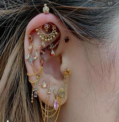 a close up of a person's ear with many different types of jewelry on it