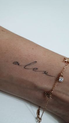 a woman's arm with a tattoo on it that says love and is written in cursive writing