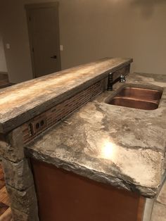 a kitchen counter top with a sink in the middle and an oven on the other side