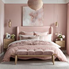 a bed with pink sheets and pillows in a bedroom next to a painting on the wall