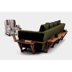 a green couch sitting on top of a wooden table