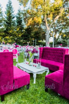 an outdoor setting with pink chairs and tables