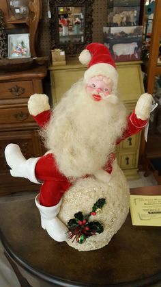 a santa clause figurine sitting on top of a table