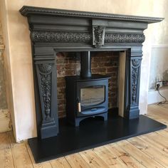 an old fashioned fireplace with a wood burning stove