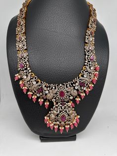 Victorian Mehndi Finish AD Polki Red Stone Pink Beads Long Statement Necklace with Matching Screwback EarringsColor : Victorian MehndiSize : Necklace Length : 24 Inches; Earring Length : 2 inches;Stones : AD Polki Red Stone Pink Beads Pearls Red Chandbali Temple Necklace With Stone Work, Red Chandbali Necklace With Intricate Design, Red Bollywood Temple Necklace With Stone Work, Red Bohemian Kundan Necklace For Diwali, Red Bohemian Necklace For Diwali, Bohemian Red Necklaces For Diwali, Bohemian Red Necklace For Diwali, Red Bollywood Necklaces With Stone Work, Pink Traditional Necklace With Stone Work