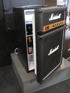 an amperator refrigerator is on display in a room with black walls and flooring