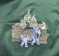 an embroidered elephant on a green background