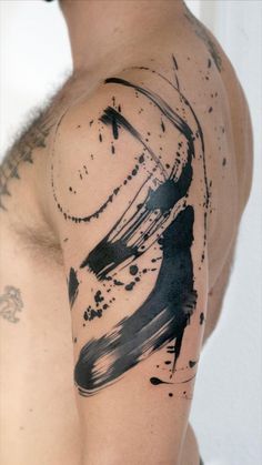 a man's arm with black ink on it that has a clock and paint splatters all over it