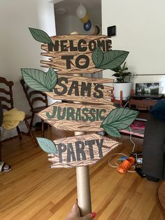 a wooden sign that says welcome to sam's jurasic party