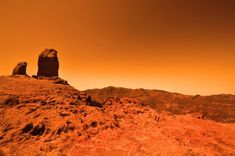 an image of some rocks in the middle of desert land that looks like something out of space