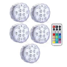 four white leds with remote control for the light up projector lights are shown in front of each other