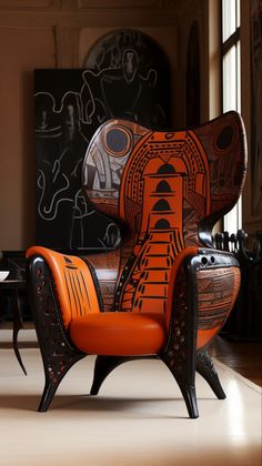 an orange chair sitting on top of a hard wood floor