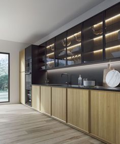 a modern kitchen with wooden cabinets and marble counter tops, along with sliding glass doors