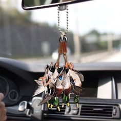 several ducks hanging from the dashboard of a car