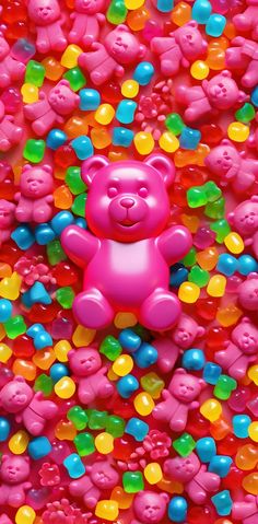 a pink teddy bear surrounded by gummy bears