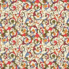 an orange, blue and green floral pattern on white fabric with lots of swirls