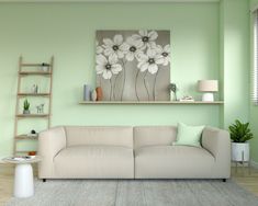 a living room with green walls and white furniture in the center, along with a painting on the wall