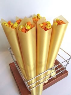 a bunch of food wrapped in paper on top of a metal rack