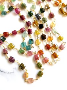 Multi Tourmaline Rosary Chain | Gemstone Beaded Chain SIZE - 3x3  to 5x5 MM Squares Gemstone Chain, Jewelry making Chain, Handmade Chain SIZE - 3x3  to 5x5 MM  Approximately  Stone Cut - Faceted Stone - Tourmaline Material - Brass  Natural Watermelon Tourmaline   Length - 1/2/3/4/5/ Feet  Contact for bulk Quarries Multicolor Rectangular Gemstone Beads Jewelry, Multicolor Crystal Chain Jewelry, Multicolor Tourmaline Gemstone Beads Necklaces, Handmade Multicolor Tourmaline Necklaces, Multicolor Faceted Tourmaline Necklaces, Multicolor Faceted Tourmaline Beaded Jewelry, Rosary Necklace, Rosary Chain, Watermelon Tourmaline