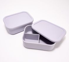 two white containers sitting on top of each other with one open and the other closed