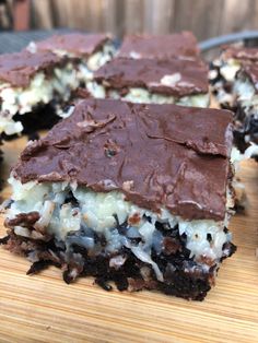 chocolate and marshmallows are cut into squares on a cutting board with one slice taken out