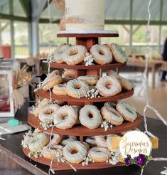 a three tiered cake with donuts on it