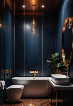 a modern bathroom with blue walls and gold trimmings, two sinks, a toilet and a bathtub